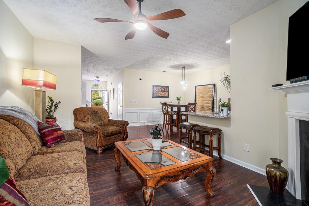 771 Nehemiah Lane Atlanta, GA 30331 - Photo 15 of 30 a living room with furniture a flat screen tv and kitchen view