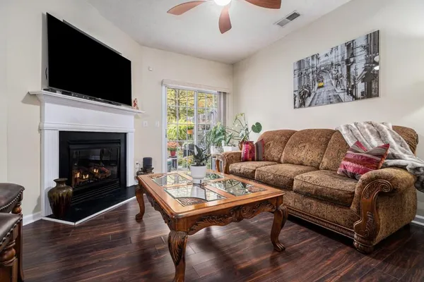 a living room with furniture a flat screen tv and a fireplace