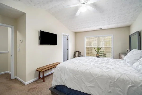 a bedroom with a bed and a flat screen tv