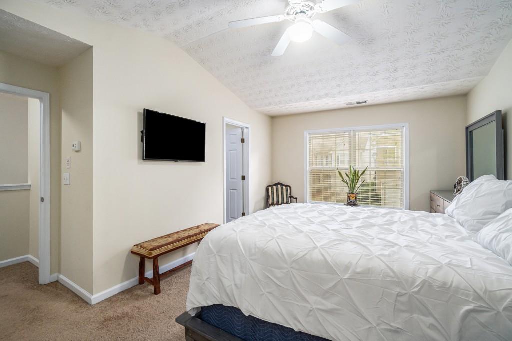 771 Nehemiah Lane Atlanta, GA 30331 - Photo 17 of 30 a bedroom with a bed and a flat screen tv