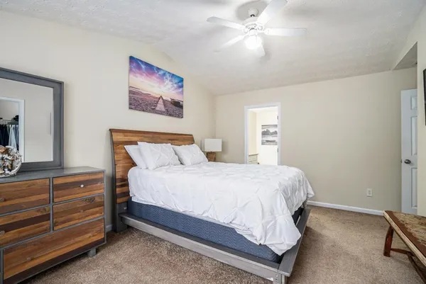 a bedroom with a bed and a chandelier