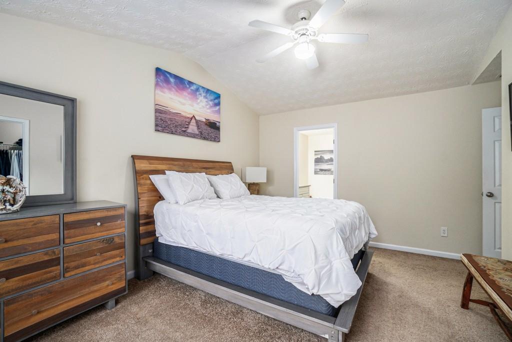 771 Nehemiah Lane Atlanta, GA 30331 - Photo 18 of 30 a bedroom with a bed and a chandelier