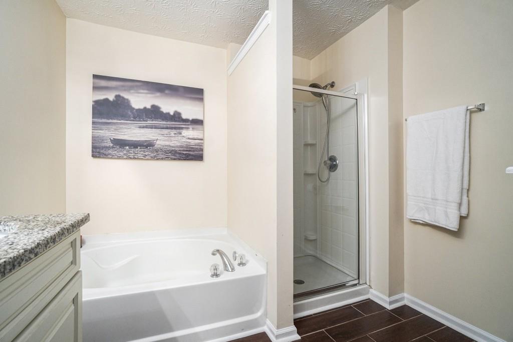 771 Nehemiah Lane Atlanta, GA 30331 - Photo 19 of 30 a bathroom with a bathtub and a shower