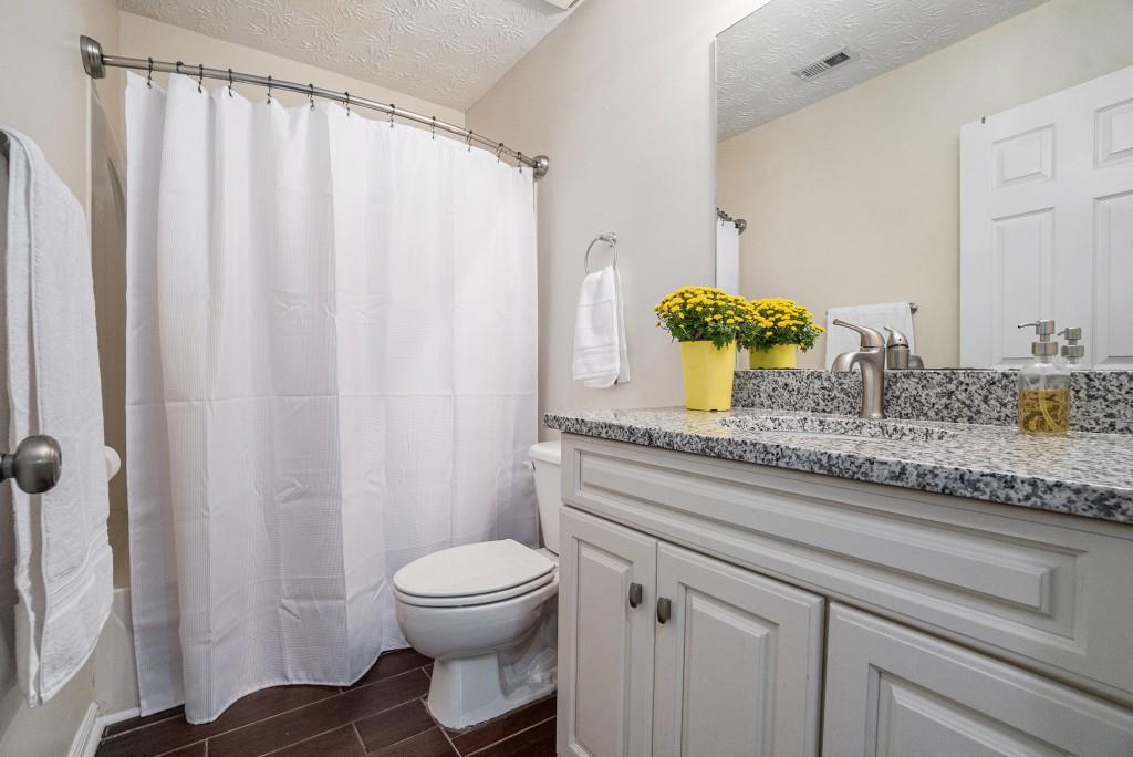 771 Nehemiah Lane Atlanta, GA 30331 - Photo 23 of 30 a bathroom with a granite countertop sink and a mirror
