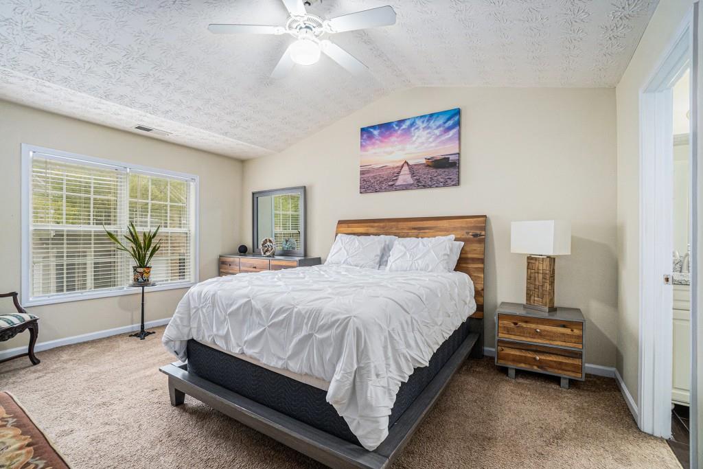 771 Nehemiah Lane Atlanta, GA 30331 - Photo 4 of 30 a spacious bedroom with a bed and a large window