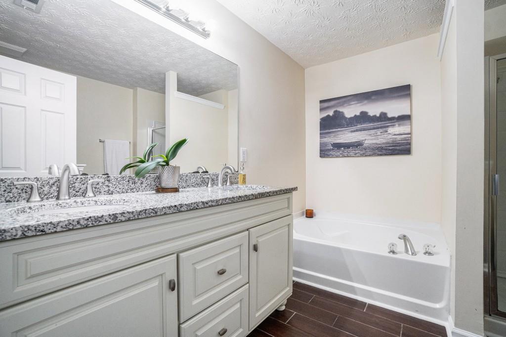 771 Nehemiah Lane Atlanta, GA 30331 - Photo 5 of 30 a bathroom with a granite countertop tub sink and mirror