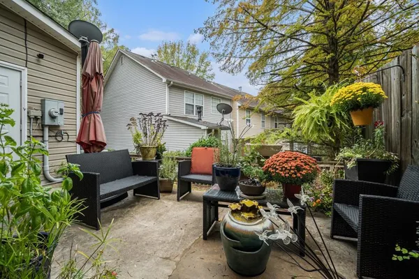 a view of a patio with couches and potted plants