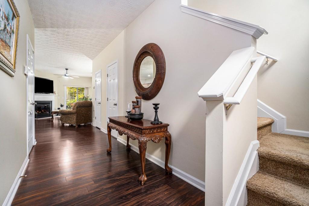 771 Nehemiah Lane Atlanta, GA 30331 - Photo 9 of 30 a living room with furniture a clock and wooden floor