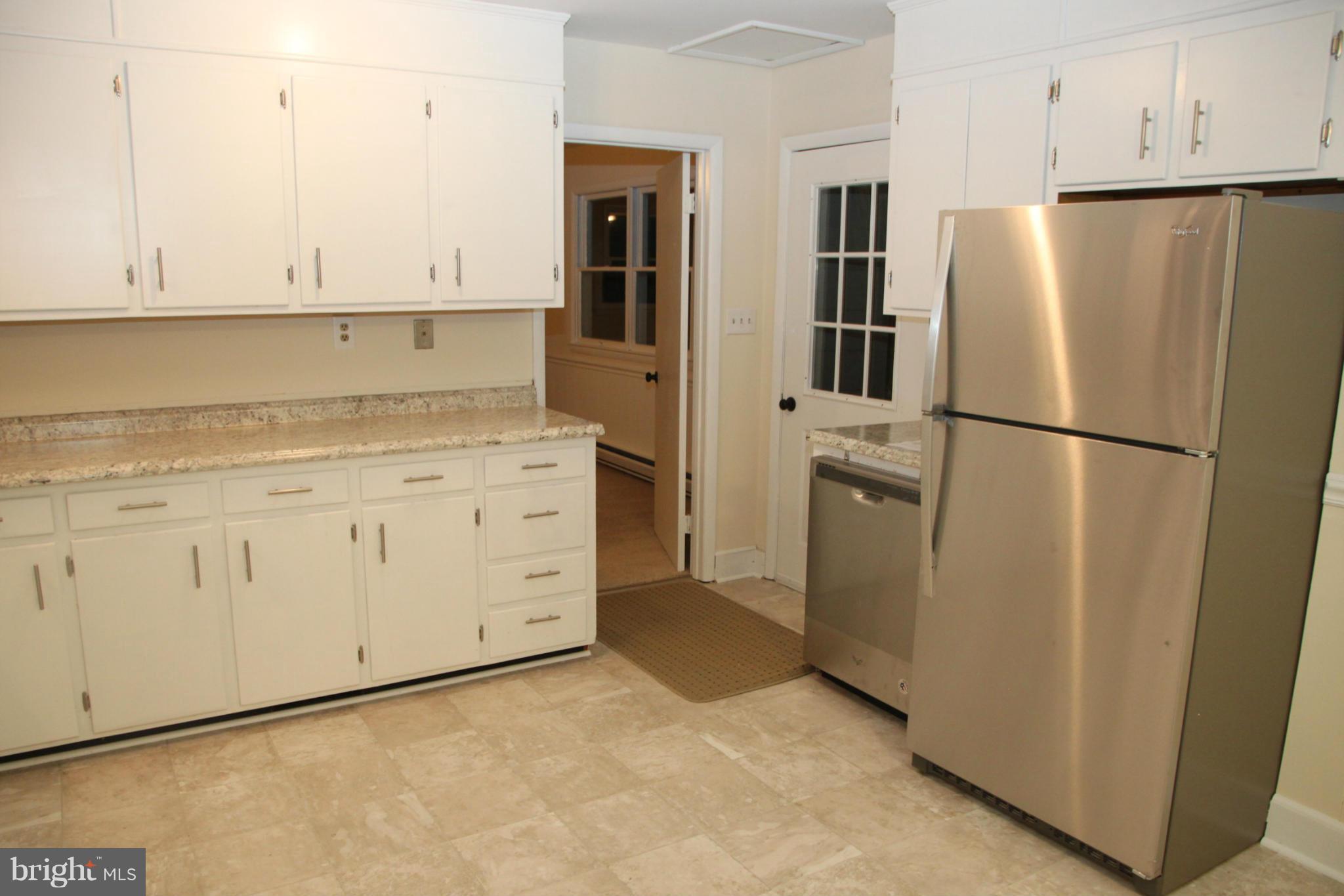 12409 Big Spring Road Clear Spring, MD 21722 - Photo 17 of 20 a white refrigerator freezer sitting in a kitchen