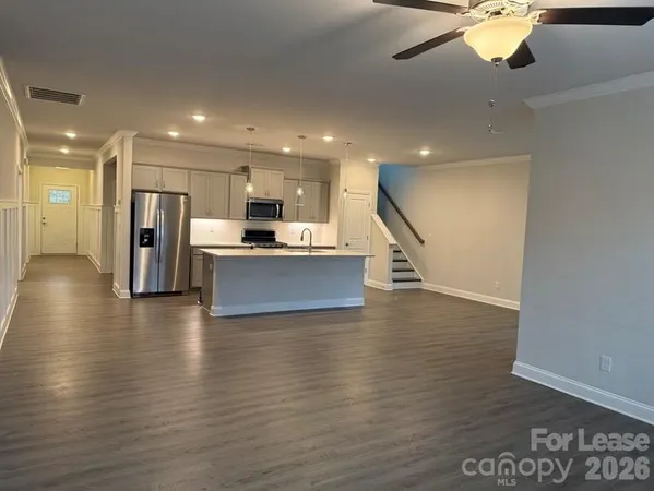 a view of a kitchen with a sink and a refrigerator
