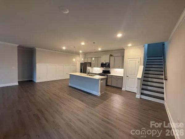 a view of kitchen with wooden floor and electronic appliances