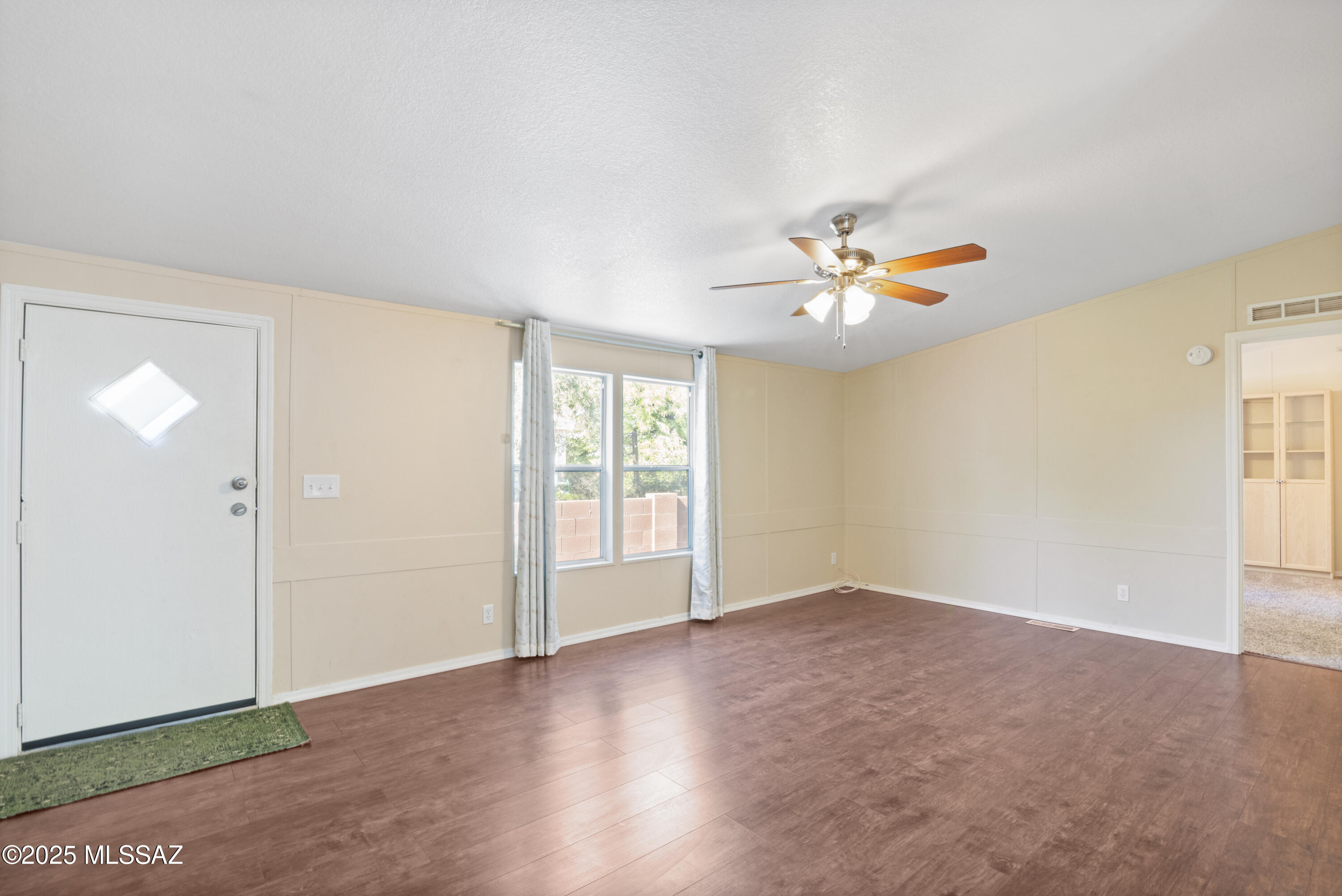 6205 East Rough Rock Drive Tucson, AZ 85756 - Photo 8 of 30 an empty room with fan and windows