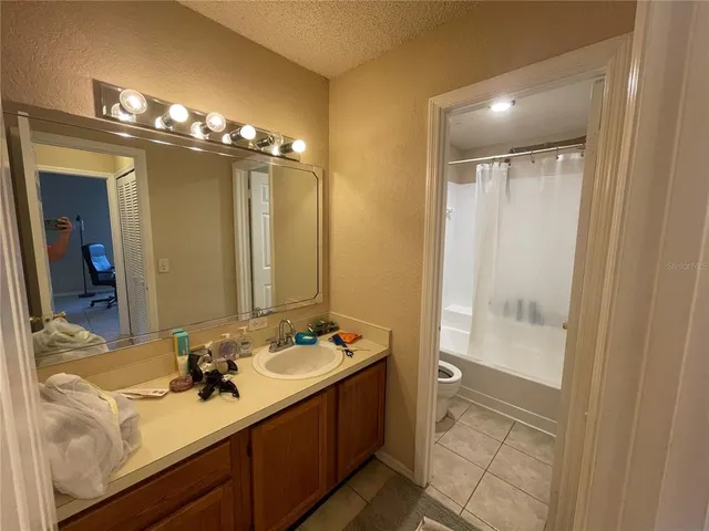 a bathroom with a double vanity sink a mirror and a shower