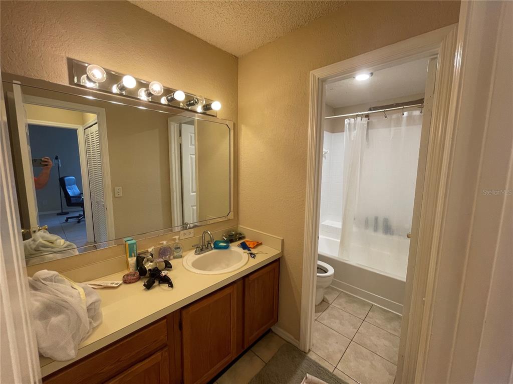 3044 Antique Oaks Circle, Unit 178 Winter Park, FL 32792 - Photo 6 of 9 a bathroom with a double vanity sink a mirror and a shower
