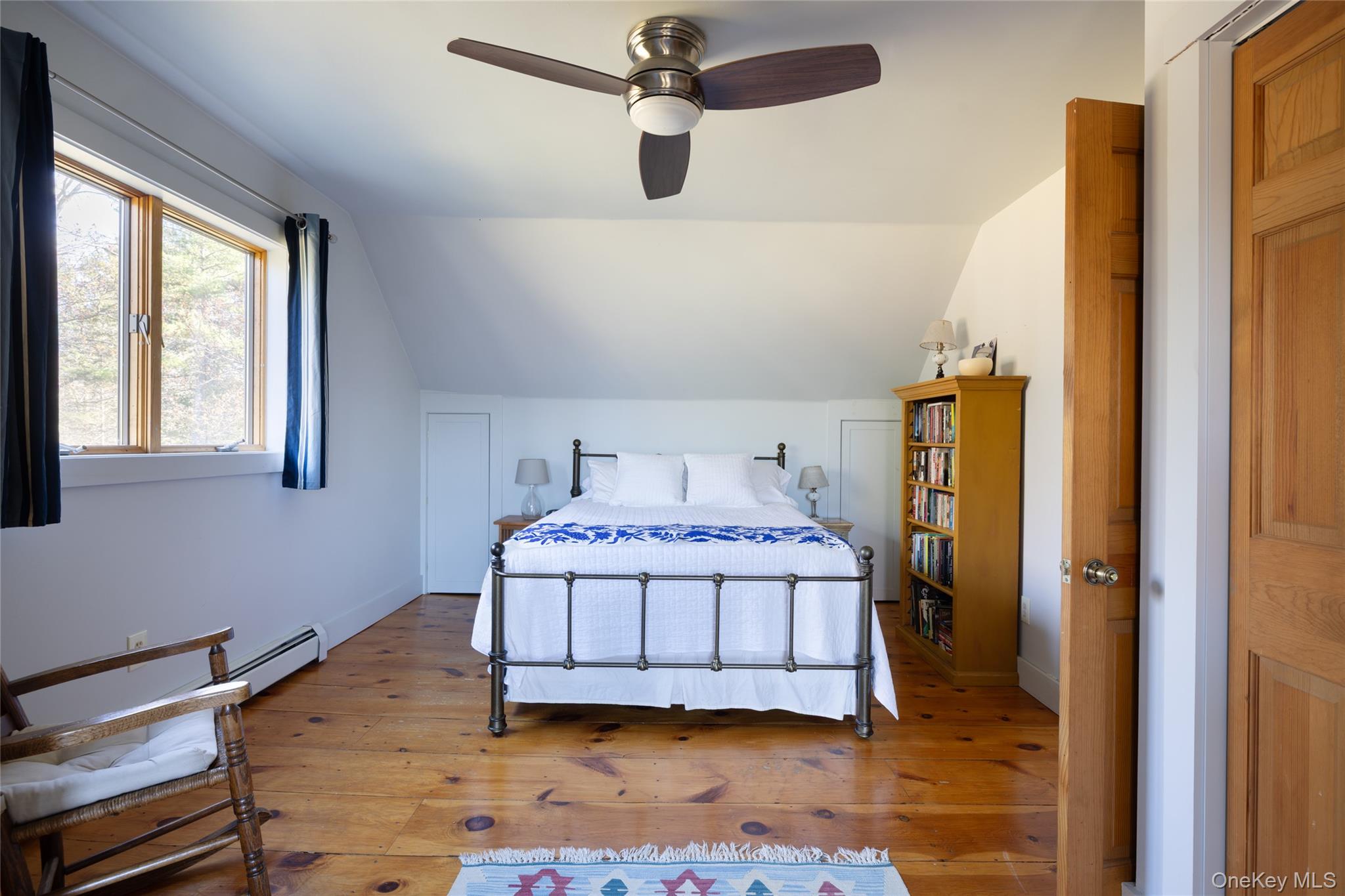 827 Ashokan Road Kingston, NY 12401 - Photo 17 of 36 a bedroom with a bed and wooden floor