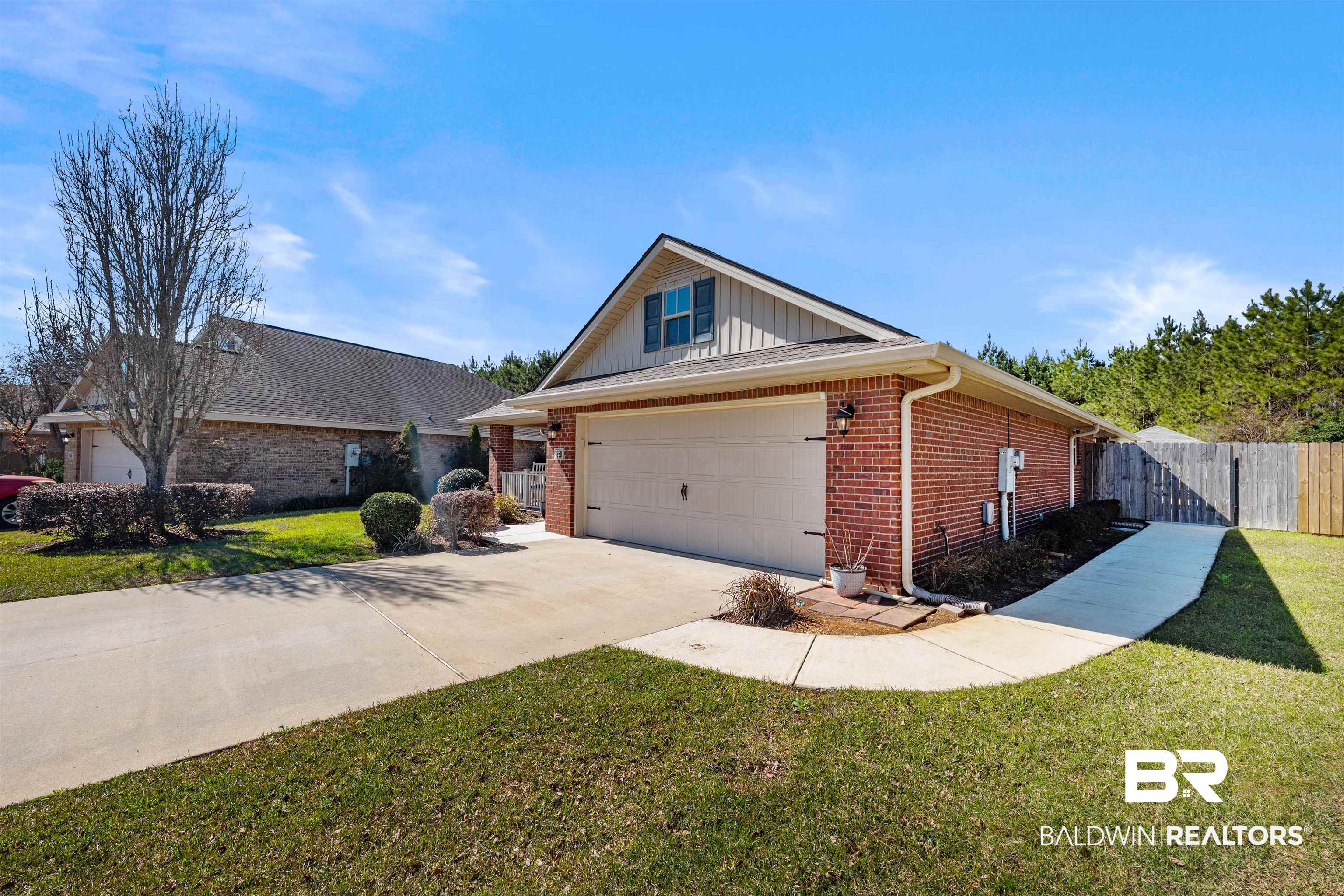 1850 Arcadia Drive Foley, AL 36535 - Photo 3 of 44 View of front of house featuring brick siding, concrete driveway, fence, a garage, and a front lawn