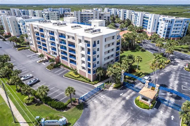 a large building with a swimming pool and outdoor seating