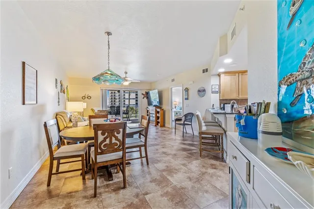 a dining room with furniture a chandelier and wooden floor