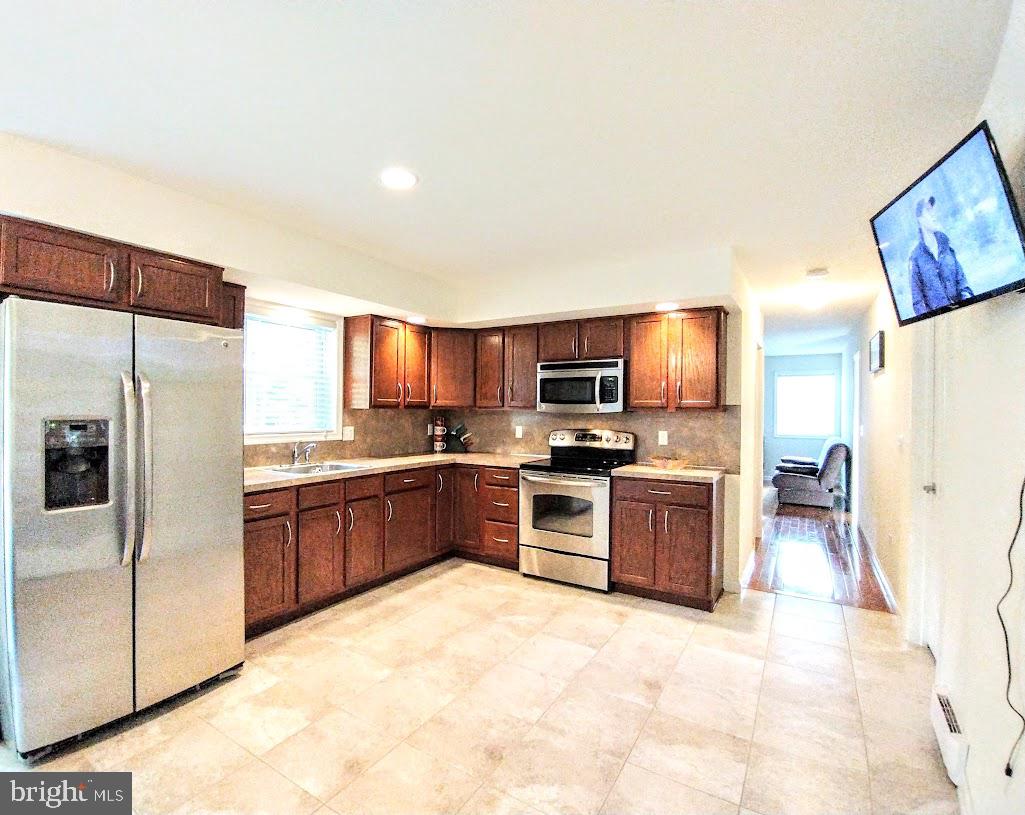 641 Main Washington, NJ 07882 - Photo 5 of 24 a large kitchen with cabinets wooden floor and stainless steel appliances
