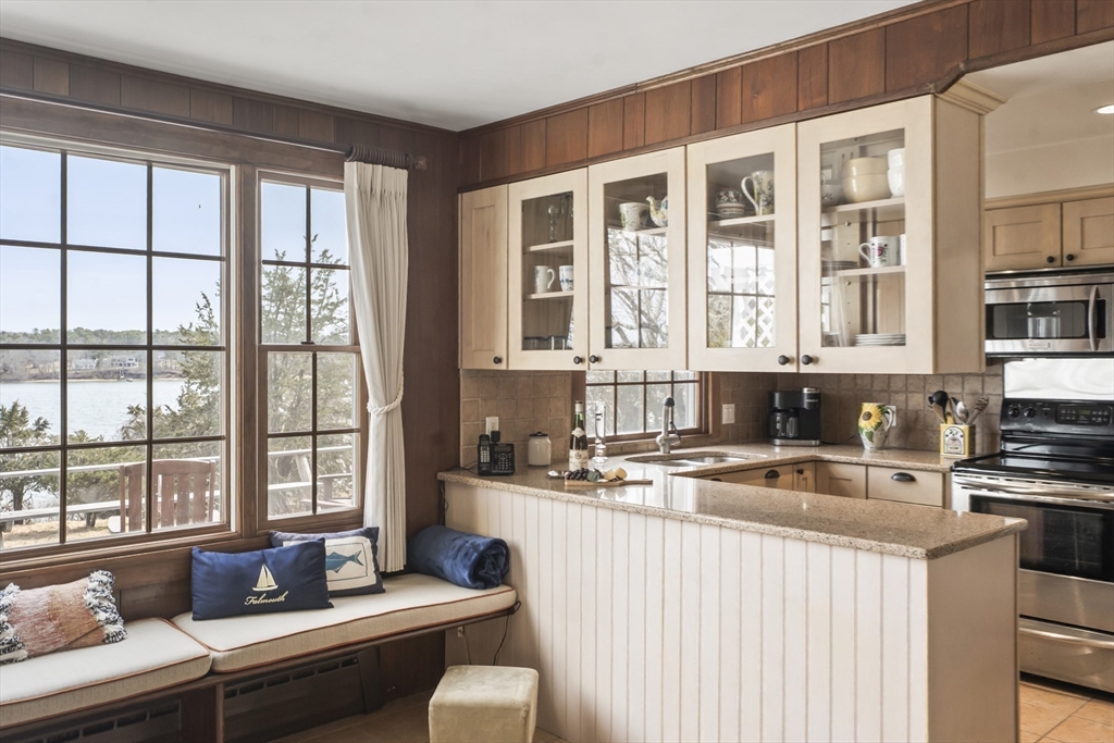 94 Weaver Lane Tisbury, MA 02568 - Photo 11 of 36 a kitchen with kitchen island a sink stove and cabinets
