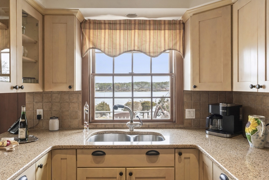 94 Weaver Lane Tisbury, MA 02568 - Photo 12 of 36 a kitchen with a refrigerator and a sink