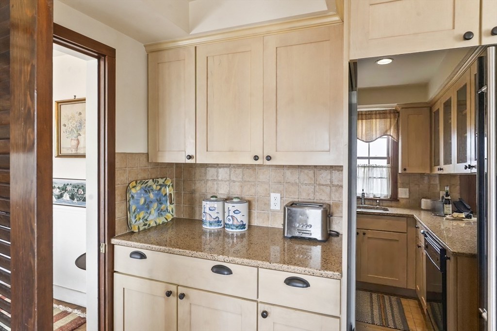 94 Weaver Lane Tisbury, MA 02568 - Photo 13 of 36 a kitchen with stainless steel appliances granite countertop a refrigerator a sink and white cabinets