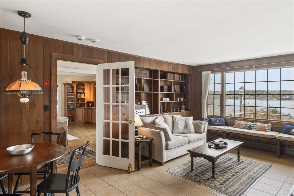 94 Weaver Lane Tisbury, MA 02568 - Photo 14 of 36 a living room with furniture and a floor to ceiling window