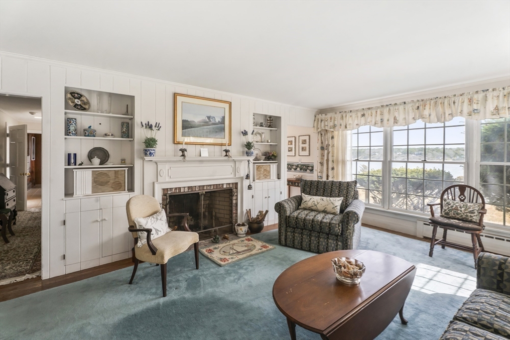 94 Weaver Lane Tisbury, MA 02568 - Photo 24 of 36 a living room with furniture and a fireplace
