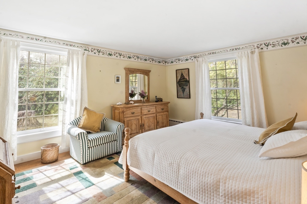 94 Weaver Lane Tisbury, MA 02568 - Photo 25 of 36 a bedroom with a bed and a couch