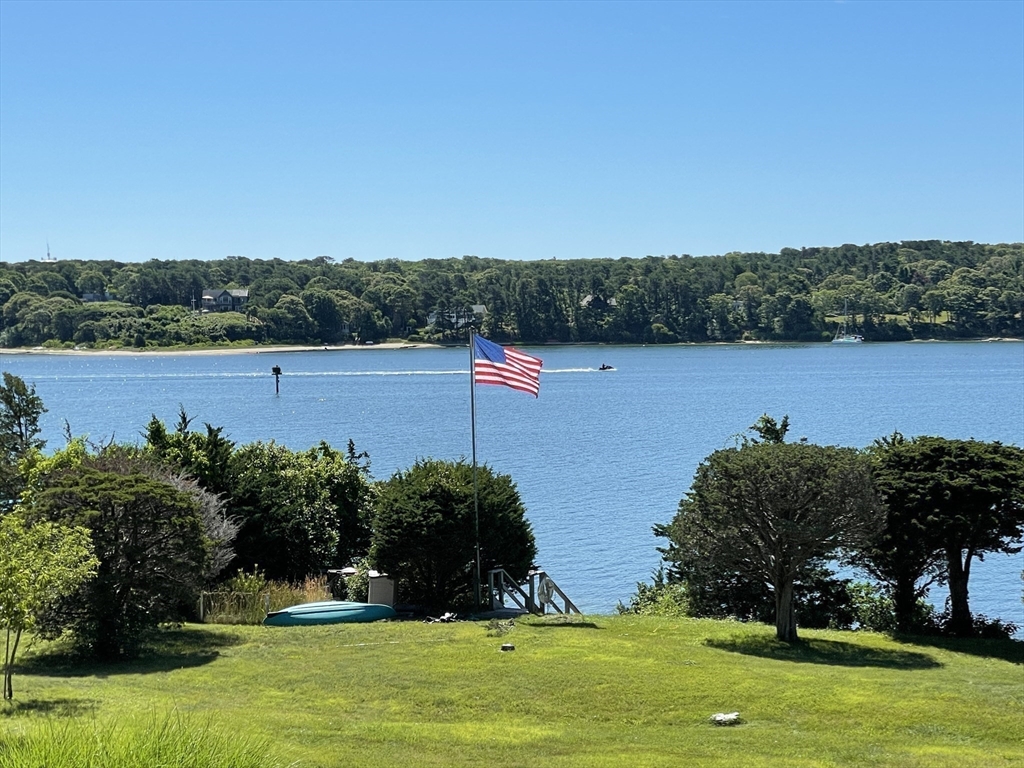 94 Weaver Lane Tisbury, MA 02568 - Photo 4 of 36 a view of a lake with houses in the back