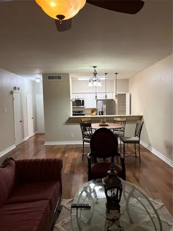 a living room with furniture and a dining table
