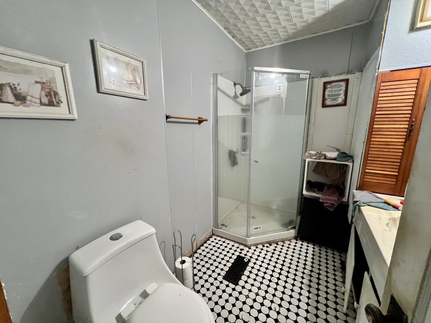 228 Tennessee Avenue Danville, IL 61832 - Photo 16 of 19 a bathroom with a sink a toilet and shower