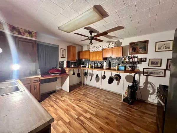 a living room with lots of furniture and a kitchen view