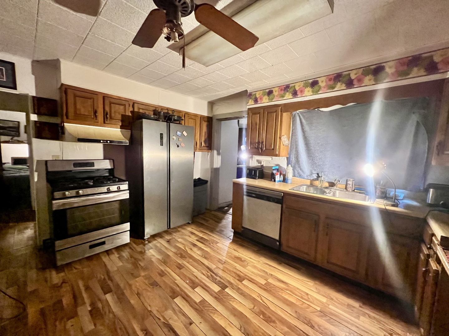 228 Tennessee Avenue Danville, IL 61832 - Photo 8 of 19 a kitchen with stainless steel appliances a refrigerator and a stove