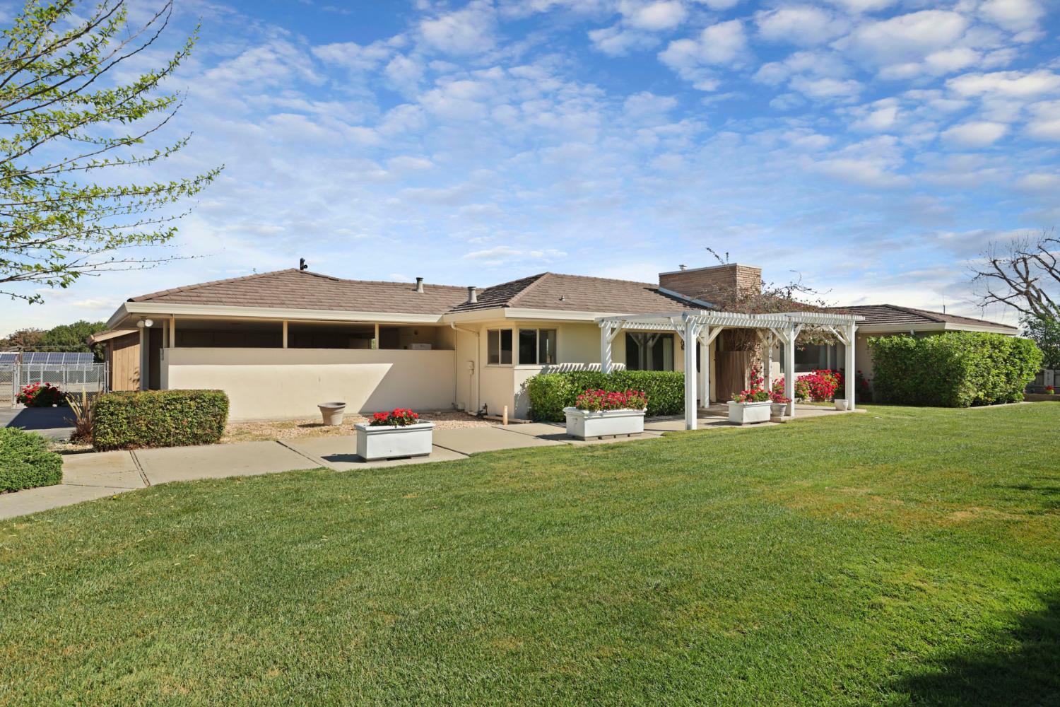 2465 Vernalis Road Tracy, CA 95304 - Photo 1 of 55 a front view of a house with a garden and porch