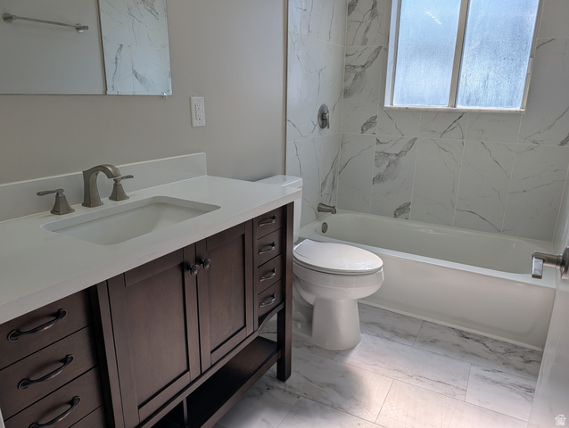 2880 Merton Way Magna, UT 84044 - Photo 9 of 30 Modern bathroom featuring a dark wood vanity with a white countertop, an integrated sink, and brushed nickel fixtures