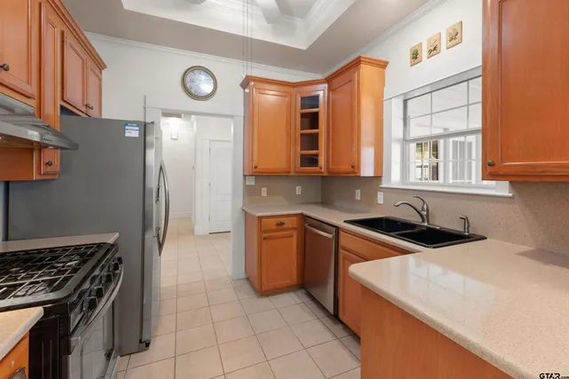 a kitchen with stainless steel appliances granite countertop a stove and a sink