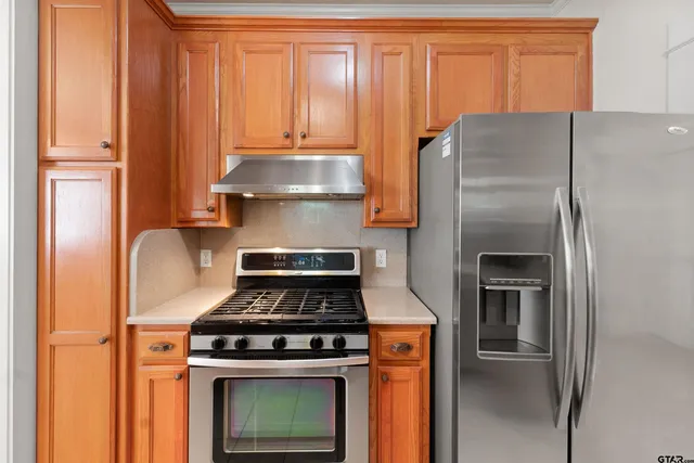 a kitchen with a stove and a refrigerator