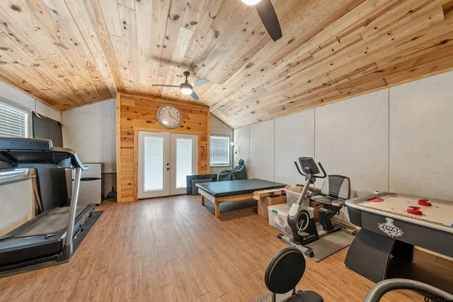 a living room with furniture gym equipment and a large window