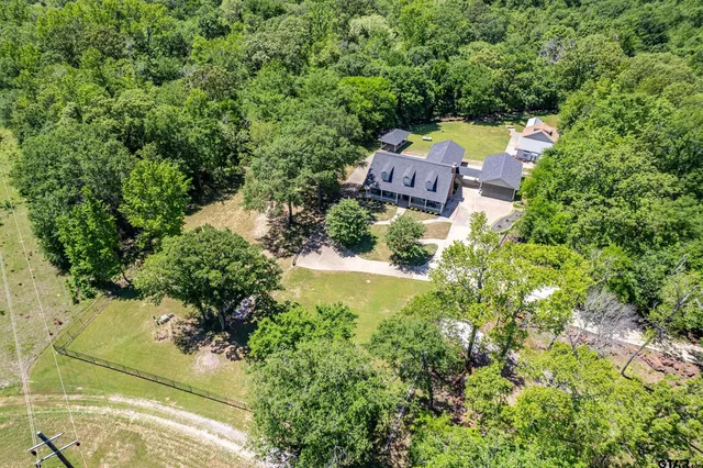 an aerial view of a house with a yard