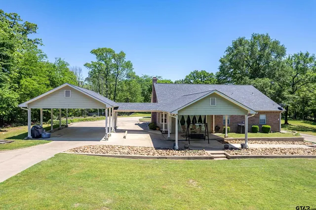a front view of a house with a yard table and chairs