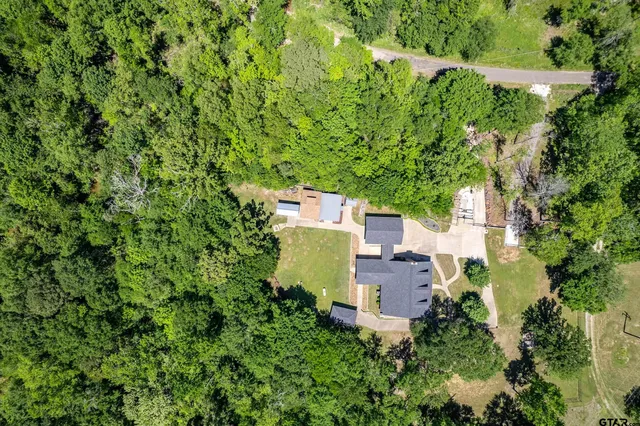 an aerial view of a house with a yard