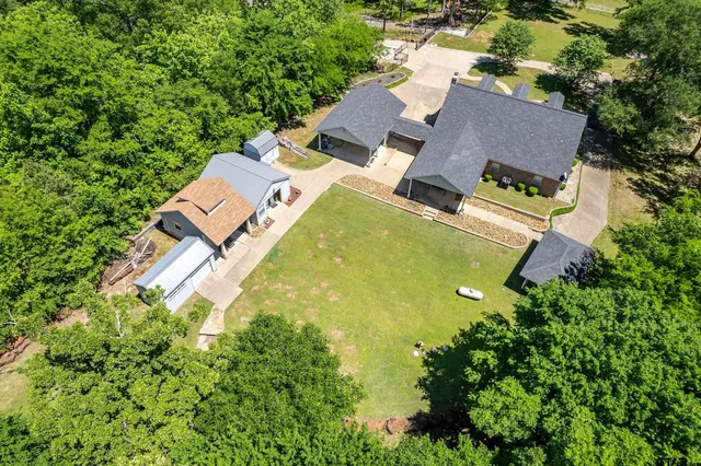 an aerial view of a house with swimming pool and outdoor space