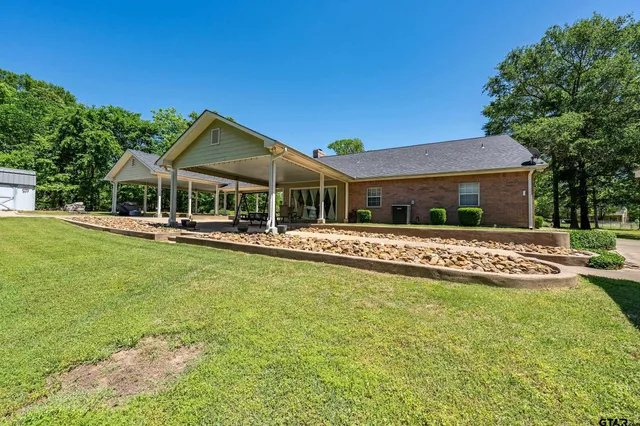 a front view of a house with a yard table and chairs