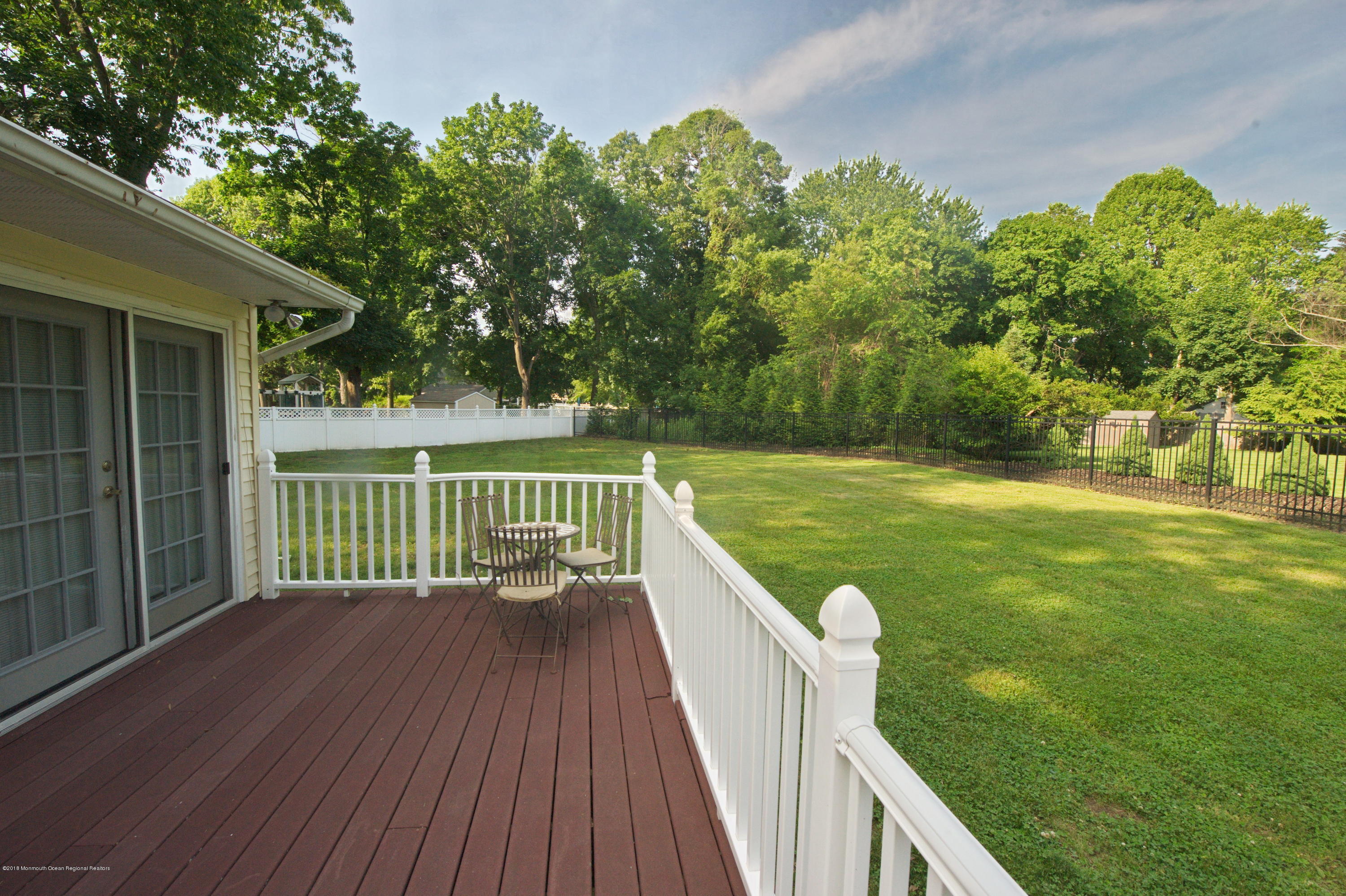 17 High Point Road Lincroft, NJ 07738 - Photo 11 of 39 a view of a balcony with wooden floor and fence