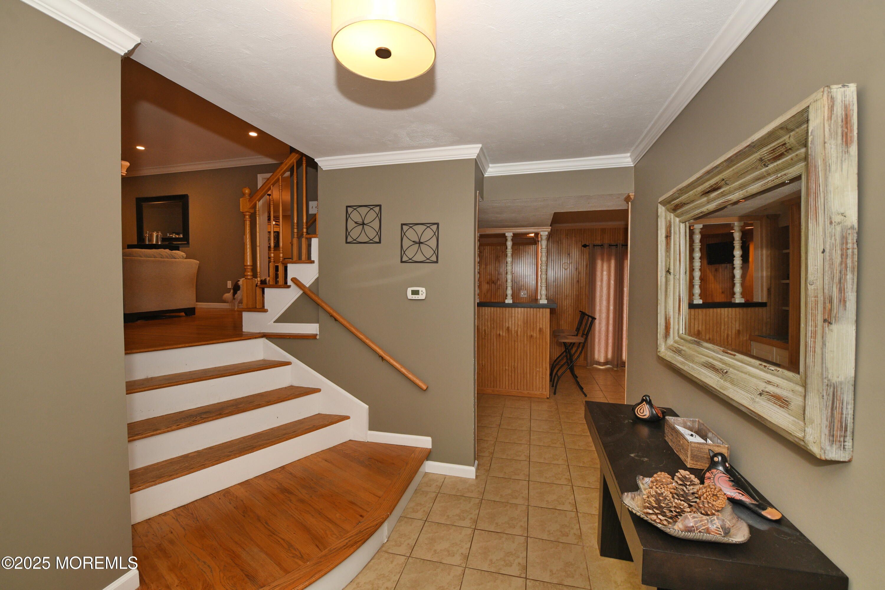 17 High Point Road Lincroft, NJ 07738 - Photo 13 of 39 a view of a hallway with a couch and chandelier