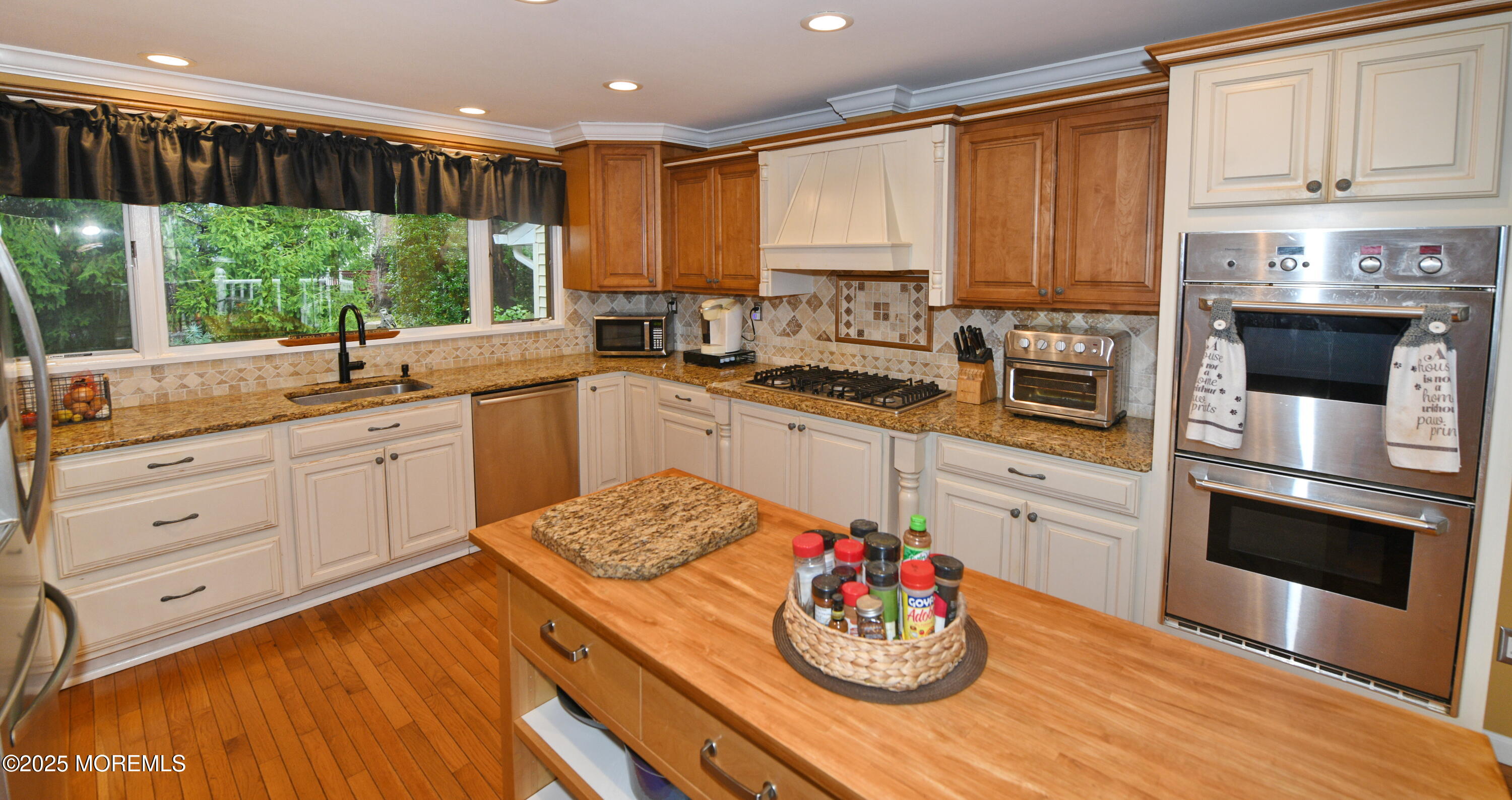 17 High Point Road Lincroft, NJ 07738 - Photo 21 of 39 a kitchen with stainless steel appliances kitchen island granite countertop a stove a sink and white cabinets