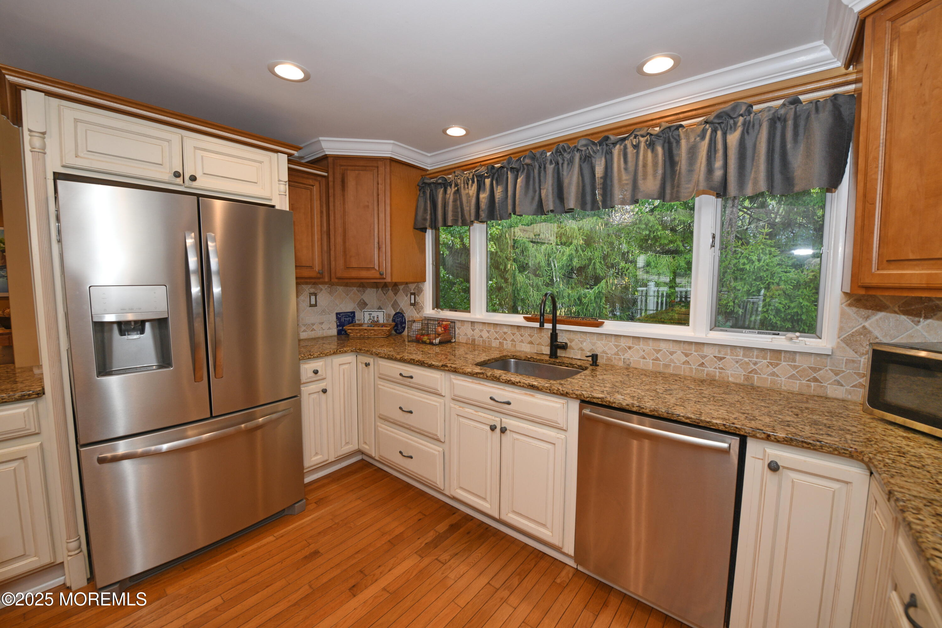 17 High Point Road Lincroft, NJ 07738 - Photo 22 of 39 a kitchen with stainless steel appliances granite countertop a refrigerator a sink and white cabinets with wooden floor