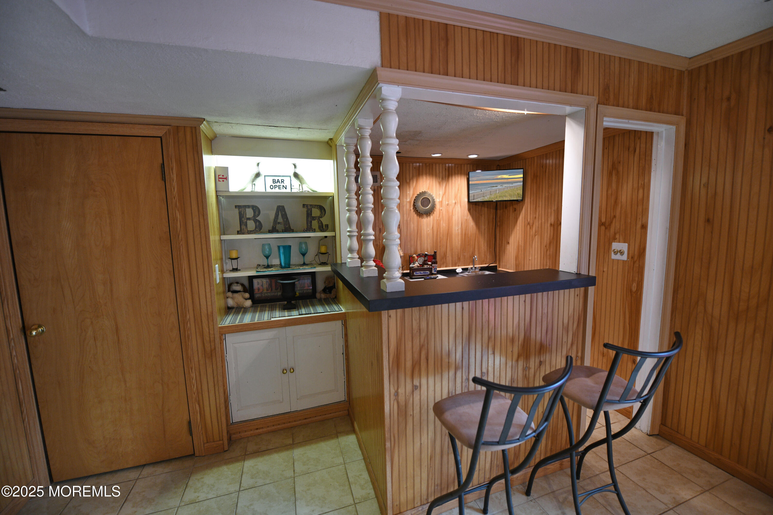 17 High Point Road Lincroft, NJ 07738 - Photo 37 of 39 a view of a hallway that has a dining table and a mirror