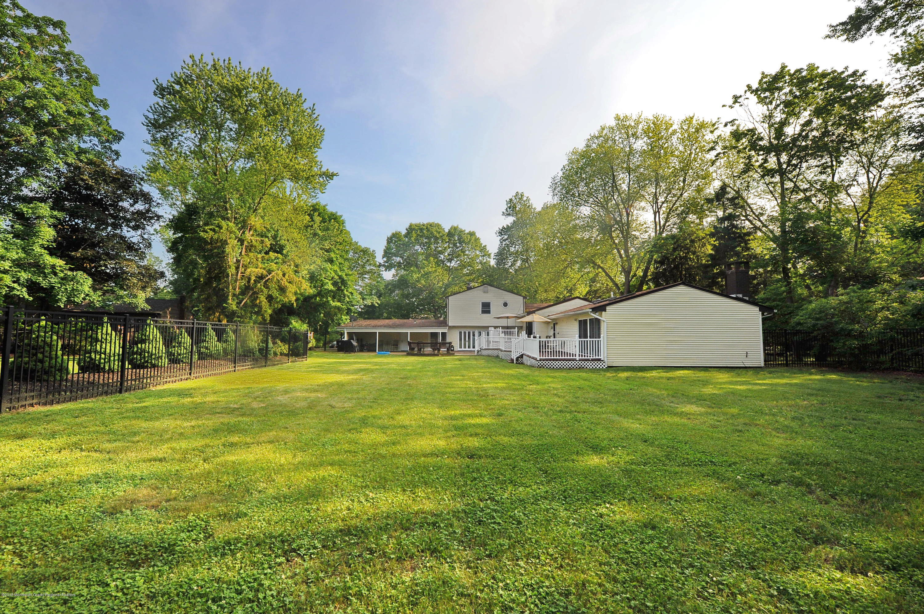 17 High Point Road Lincroft, NJ 07738 - Photo 5 of 39 a front view of a house with a yard and trees